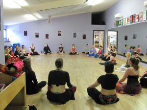 Dancers gather in a circle.